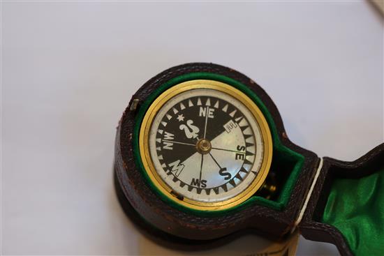 A cased pocket barometer / compass, together with a brass pocket barometer